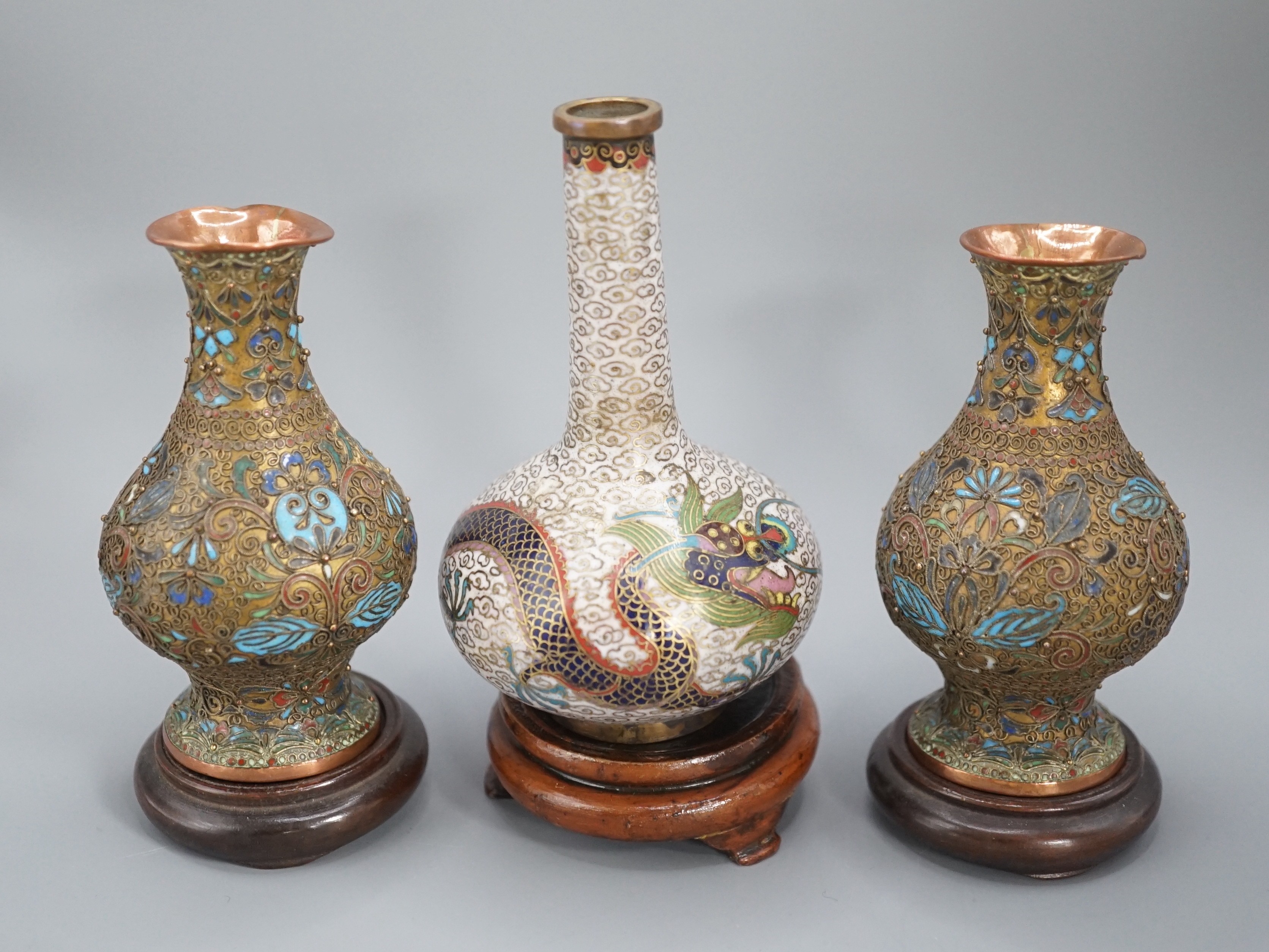 A Chinese cloisonne enamel ‘dragon’ bottle vase, early 20th century and a pair of Japanese cloisonne enamel vases with wood stands 10.5cm
